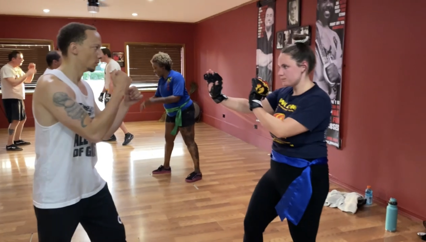 Tampa Martial Arts and Self-Defense, Student training on martial arts technique during class.