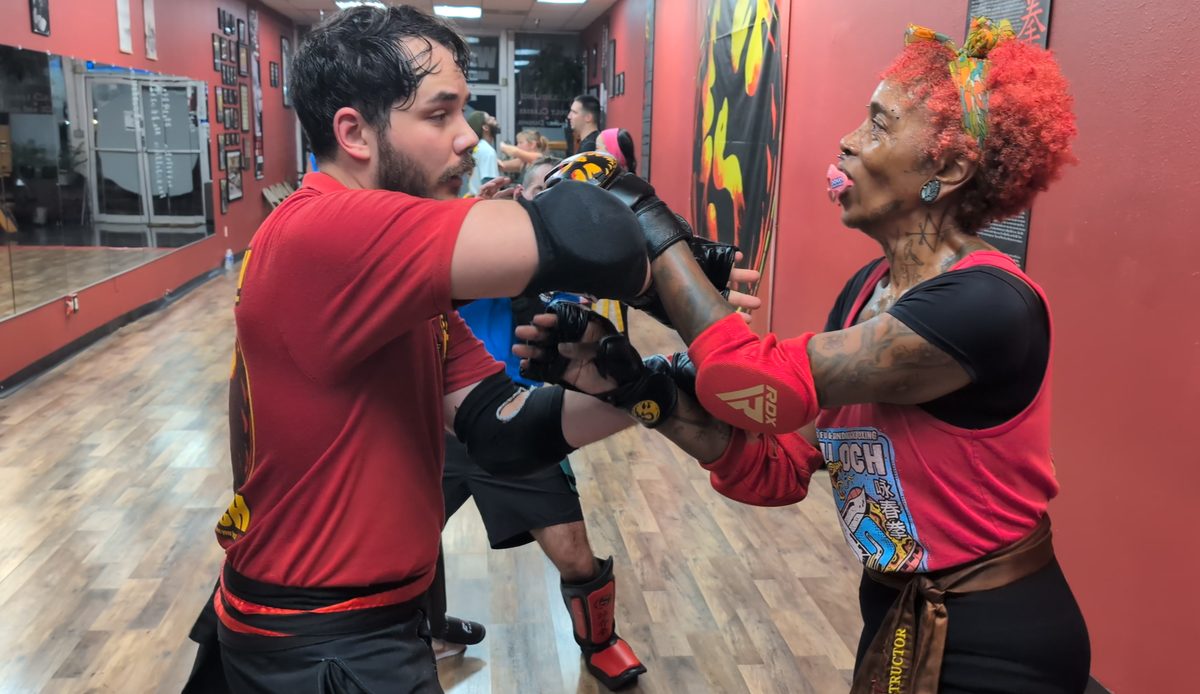 Two students in padded gloves and elbow guards practicing a Wing Chun partner drill at Tampa Wing Chun Kung Fu