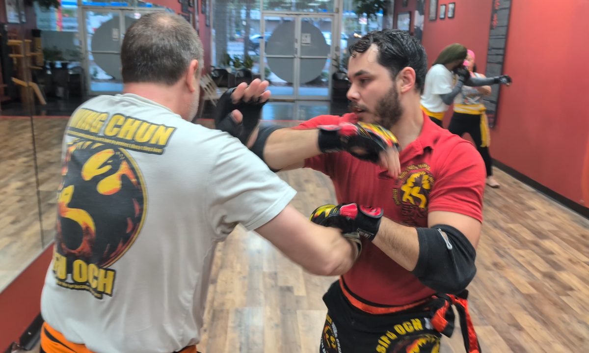 Two students practicing a Wing Chun partner drill in the studio at Tampa Wing Chun Kung Fu