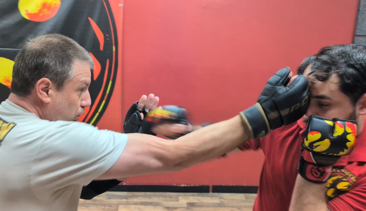 Student throwing a gloved punch during a Wing Chun partner drill at Tampa Wing Chun Kung Fu